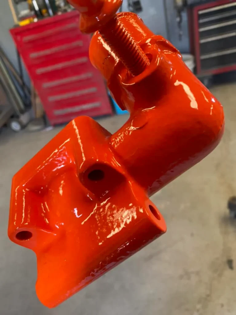 orange powder coated metal part